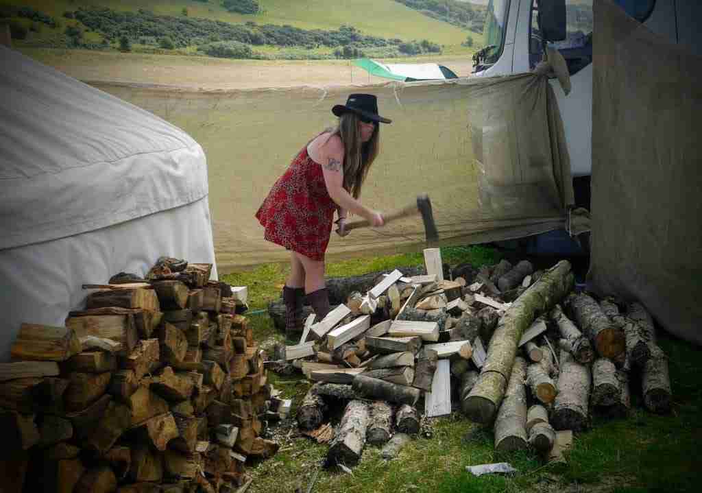 The writer chopping a pile of wood with a hand axe