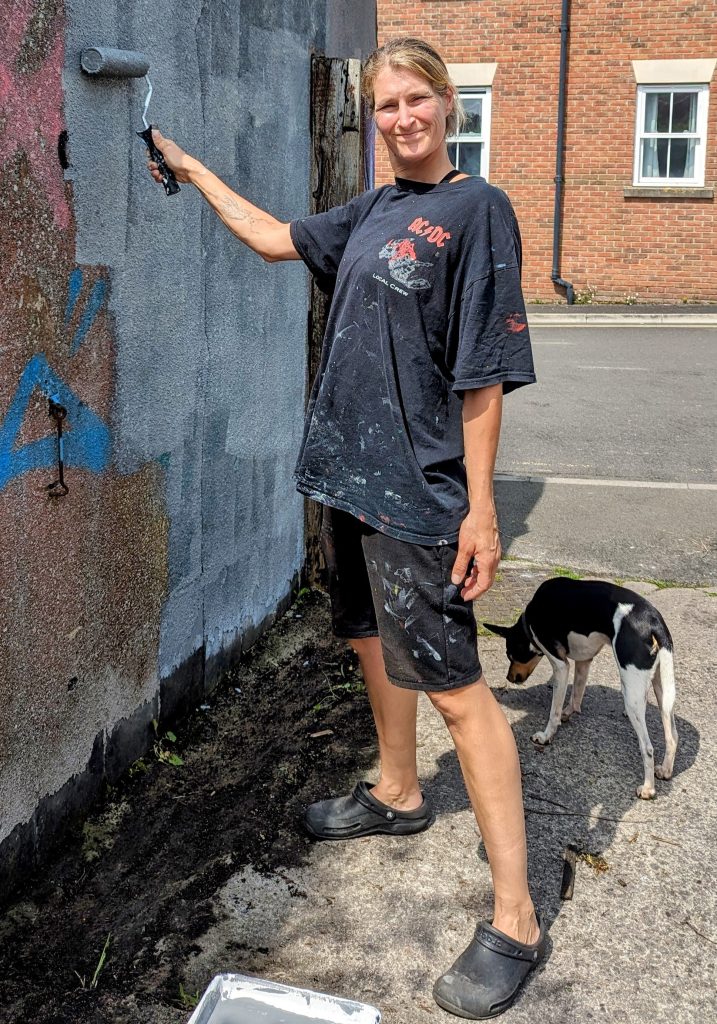 Kim painting a wall